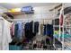 Walk-in closet featuring ample hanging space, shelving, and shoe storage at 7324 Links Ct, Sarasota, FL 34243