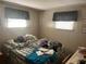 Simple bedroom with natural light, window coverings and space for relaxation at 733 Roma Rd, Venice, FL 34285