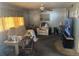 Cozy living room with comfortable seating, a ceiling fan, and a large television at 733 Roma Rd, Venice, FL 34285