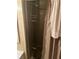Shower with a glass door and a neutral-toned shower curtain, complete with shower head and storage rack at 733 Roma Rd, Venice, FL 34285
