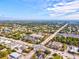 Expansive aerial view of the neighborhood featuring lush greenery, clear blue skies, and a well-connected road network at 7970 Lakes Edge Ln, Port Charlotte, FL 33981