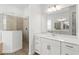 Modern bathroom with a glass-enclosed shower, quartz counters, and elegant finishes at 7970 Lakes Edge Ln, Port Charlotte, FL 33981