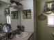 Bathroom with vanity sink, decorative wall art and a window at 805 S Waterway, Venice, FL 34285