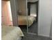 Bedroom features a mirrored closet and comfortable bedding at 805 S Waterway, Venice, FL 34285