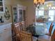 Dining area featuring a glass-top table, chandelier, and stylish décor at 805 S Waterway, Venice, FL 34285