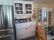 Kitchen featuring stainless steel refrigerator, white cabinets and dining area at 805 S Waterway, Venice, FL 34285