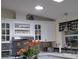 Bright kitchen with overhead light, white cabinets, modern appliances and decorative features at 805 S Waterway, Venice, FL 34285