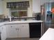 Kitchen featuring white cabinets, stainless steel appliances and a decorative window at 805 S Waterway, Venice, FL 34285