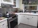 Updated kitchen featuring modern appliances, light countertops and stainless steel backsplash at 805 S Waterway, Venice, FL 34285