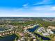 Panoramic aerial view highlighting the community's serene lakefront setting and lush surroundings at 915 Tartan Dr # 29, Venice, FL 34293