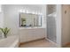 Bathroom featuring double sinks, a glass enclosed shower and a tub at 915 Tartan Dr # 29, Venice, FL 34293