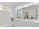 Bright bathroom featuring double sinks, stained glass window, and tub at 915 Tartan Dr # 29, Venice, FL 34293