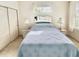 Comfortable bedroom showcasing twin beds, side tables with lamps, and mirrored headboard at 915 Tartan Dr # 29, Venice, FL 34293