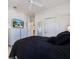 This bedroom features a black bed set, white dresser, and a television on the dresser at 915 Tartan Dr # 29, Venice, FL 34293