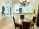 Elegant dining room with chandelier lighting and kitchen counter view at 915 Tartan Dr # 29, Venice, FL 34293