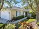 Charming single-story home with lush landscaping, blue shutters and a tile roof at 915 Tartan Dr # 29, Venice, FL 34293