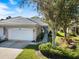 Charming single-story home showcasing a well-manicured lawn, two-car garage, and inviting curb appeal at 915 Tartan Dr # 29, Venice, FL 34293