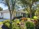 Charming home featuring a well-manicured front yard with vibrant landscaping and a welcoming entrance at 915 Tartan Dr # 29, Venice, FL 34293