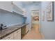 Hallway with blue walls and a view of kitchen at 915 Tartan Dr # 29, Venice, FL 34293