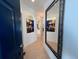 Inviting hallway featuring stylish decor and stained-glass window accents and mirror at 915 Tartan Dr # 29, Venice, FL 34293