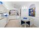 Bright kitchen features white cabinets, an arched window, and a dining area for a seamless cooking and dining experience at 915 Tartan Dr # 29, Venice, FL 34293