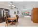 Open-concept living area featuring a chandelier, white walls, and ample seating, perfect for entertaining guests at 915 Tartan Dr # 29, Venice, FL 34293