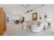 Open-concept living room and dining area with neutral carpet and a vaulted ceiling at 915 Tartan Dr # 29, Venice, FL 34293