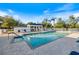 Enjoyable community pool surrounded by pavers, lounge chairs, and palm trees at 915 Tartan Dr # 29, Venice, FL 34293