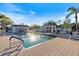Relaxing community pool featuring clear water, lounge chairs, and shaded gazebo at 915 Tartan Dr # 29, Venice, FL 34293
