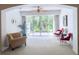 Serene sunroom with comfortable seating, ceiling fan and large glass doors opening to a lush green view at 915 Tartan Dr # 29, Venice, FL 34293