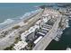 Stunning aerial view of the condo building near the beach, parking, and marina at 950 Tarpon Center Dr # 506, Venice, FL 34285