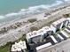 Aerial view of a condo complex next to a beautiful beach at 950 Tarpon Center Dr # 506, Venice, FL 34285