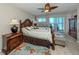 Bedroom with dark wood furniture, area rug, and sliding door to a balcony with an ocean view at 950 Tarpon Center Dr # 506, Venice, FL 34285