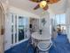 Bright dining area with ceiling fan offering spectacular ocean views through sliding glass doors at 950 Tarpon Center Dr # 506, Venice, FL 34285