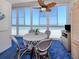 Bright dining area with ceiling fan offering spectacular ocean views through large windows at 950 Tarpon Center Dr # 506, Venice, FL 34285