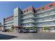 Exterior view of the building featuring multiple stories and covered parking at 950 Tarpon Center Dr # 506, Venice, FL 34285