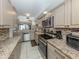 Well-lit kitchen featuring stainless steel appliances and a mirrored backsplash above the sink at 950 Tarpon Center Dr # 506, Venice, FL 34285