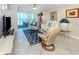 Relaxing living room with ocean view, sliding glass doors, and cozy seating arrangements at 950 Tarpon Center Dr # 506, Venice, FL 34285