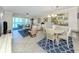 Charming living room with dining area, offering breathtaking ocean views from the sliding glass doors at 950 Tarpon Center Dr # 506, Venice, FL 34285