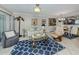Bright living room features a blue patterned rug, comfortable seating, and stylish decor at 950 Tarpon Center Dr # 506, Venice, FL 34285