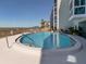 Beautiful outdoor pool with seating area and beach views at this building at 950 Tarpon Center Dr # 506, Venice, FL 34285