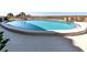 A sparkling community pool featuring comfortable lounge chairs and serene surroundings at 950 Tarpon Center Dr # 506, Venice, FL 34285
