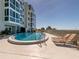 Beautiful outdoor pool surrounded by lounge chairs and ocean views at this building at 950 Tarpon Center Dr # 506, Venice, FL 34285