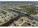 Expansive aerial view of a home on the water, set in a neighborhood with lush greenery and various waterways at 9542 Spring Cir, Port Charlotte, FL 33981
