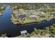 Aerial view of a waterfront property with a private dock, screened lanai, and expansive water access at 9542 Spring Cir, Port Charlotte, FL 33981