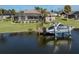 Waterfront home featuring a private dock and boat lift for enjoying boating and water activities at 9542 Spring Cir, Port Charlotte, FL 33981