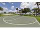 Community basketball court surrounded by palm trees, offering a scenic and active outdoor space at 9542 Spring Cir, Port Charlotte, FL 33981