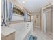 Bright bathroom features a large tub and shower with nice tile work and an abundance of natural light at 9542 Spring Cir, Port Charlotte, FL 33981