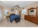 Bedroom features a ceiling fan, tile floors, neutral paint, and plenty of space with two windows for natural light at 9542 Spring Cir, Port Charlotte, FL 33981