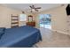Large bedroom with tile floor, nice mirror, ceiling fan and sliding glass doors leading out to the screened in pool at 9542 Spring Cir, Port Charlotte, FL 33981